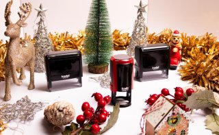 Trodat Stempelmodelle als Weihnachtsgeschenk, dekoriert mit Tannenbaum, Hirsch, Christbaumkugeln und Lebkuchenhaus