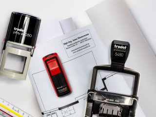 Architektin stempelt Baupläne mit Trodat Printy 46050 im Büro